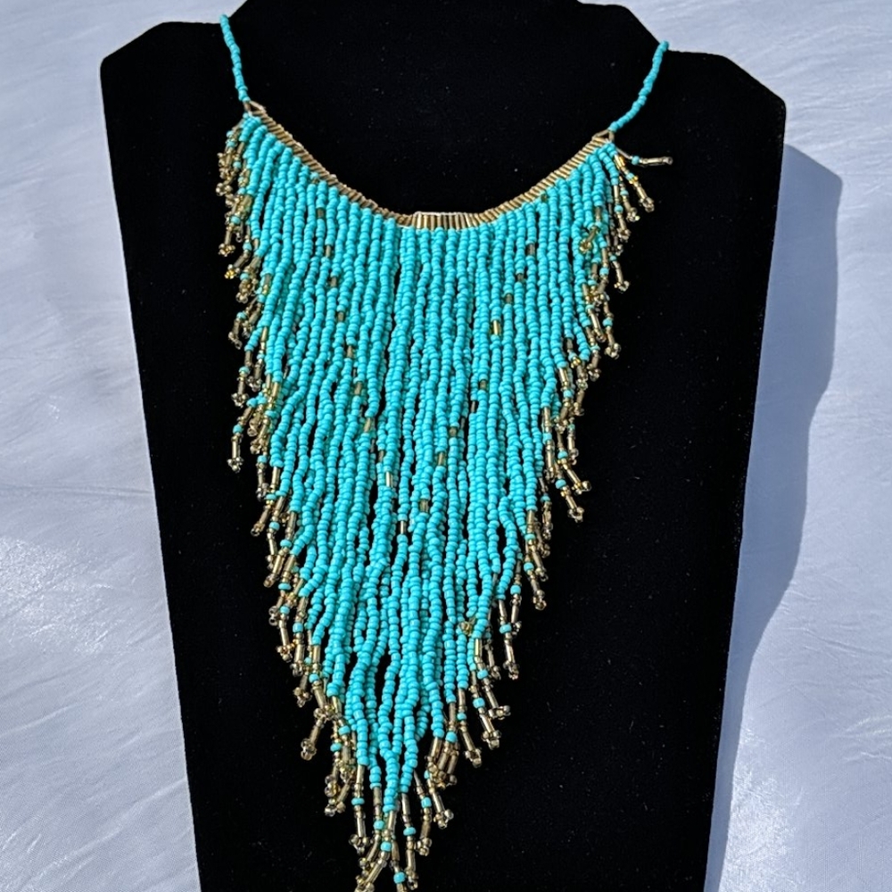 Turquoise and gold colored beaded necklace